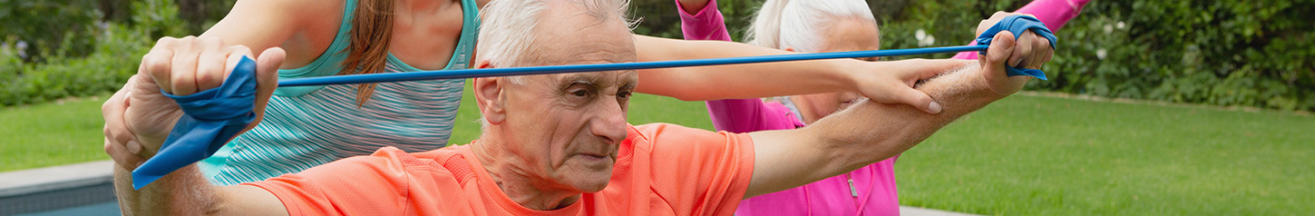 This is a banner photo image of older adults exercising outdoors 