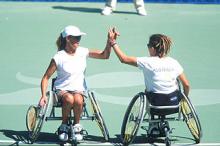 wheelchair tennis players high fiving